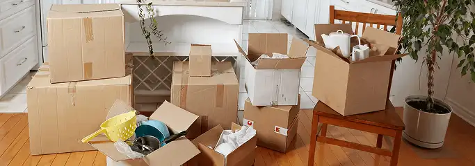 Packed moving boxes and household items in a kitchen before move-out or move-in cleaning, Minneapolis, MN.